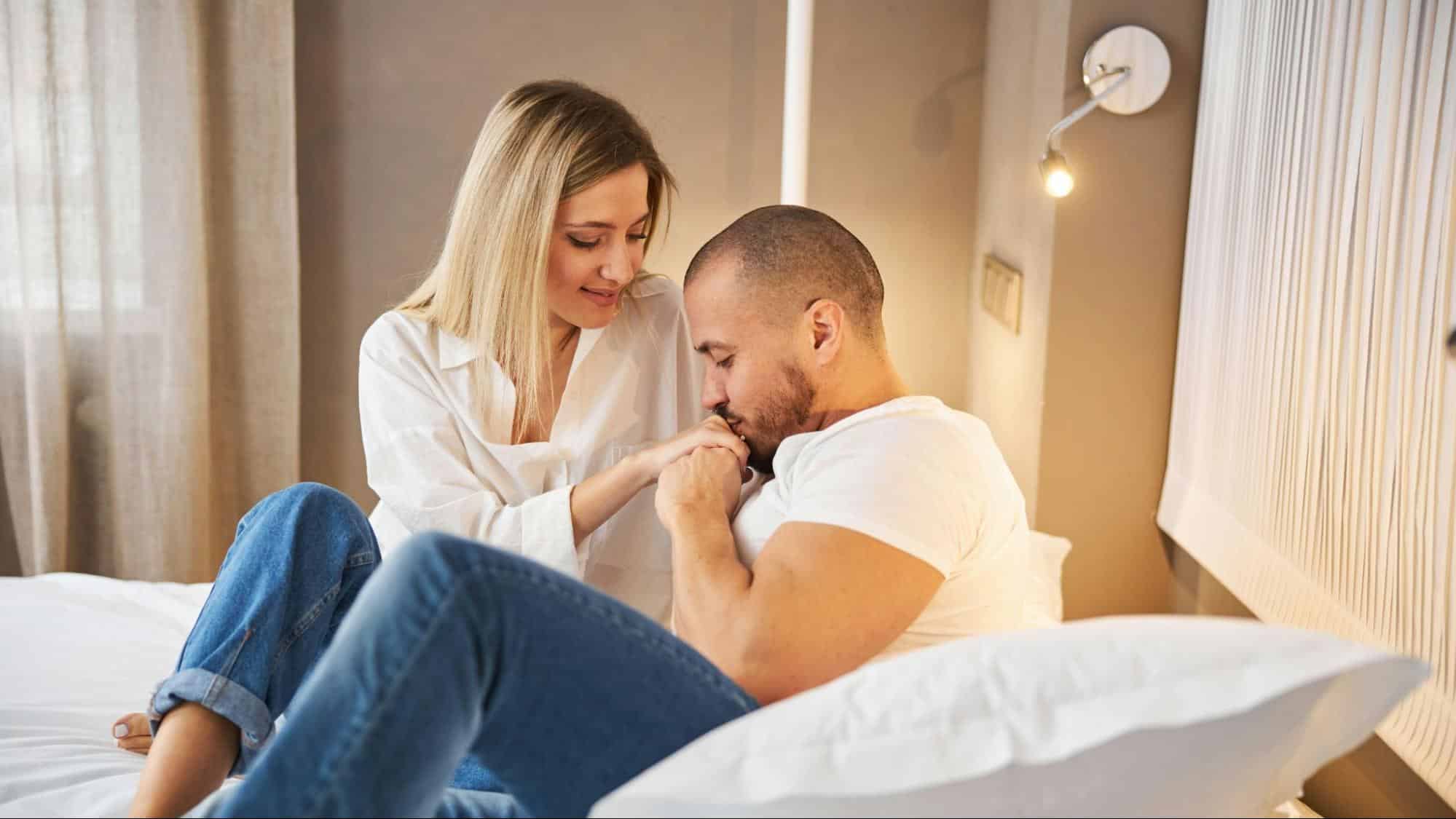 A man kissing woman’s hand