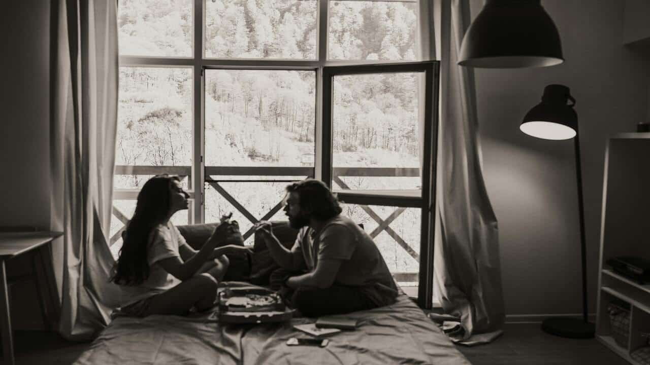 A couple eating in bed
