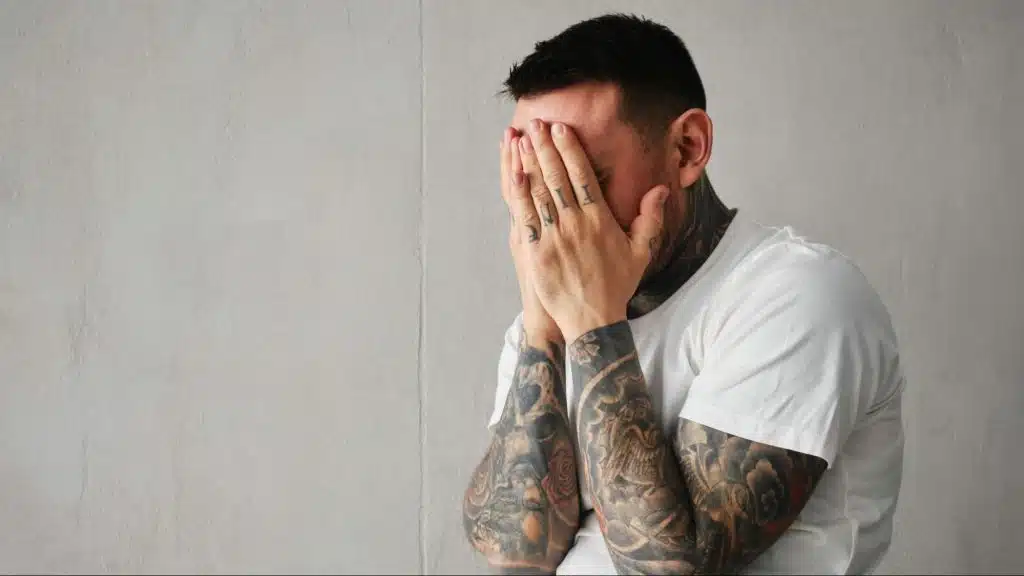Sad man covering his face