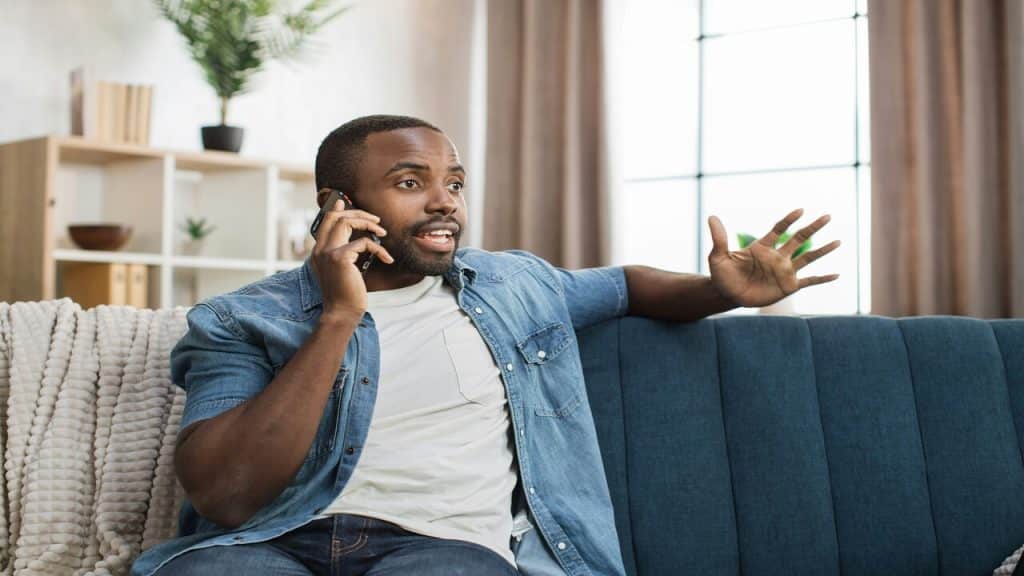 A man talking animatedly on the phone