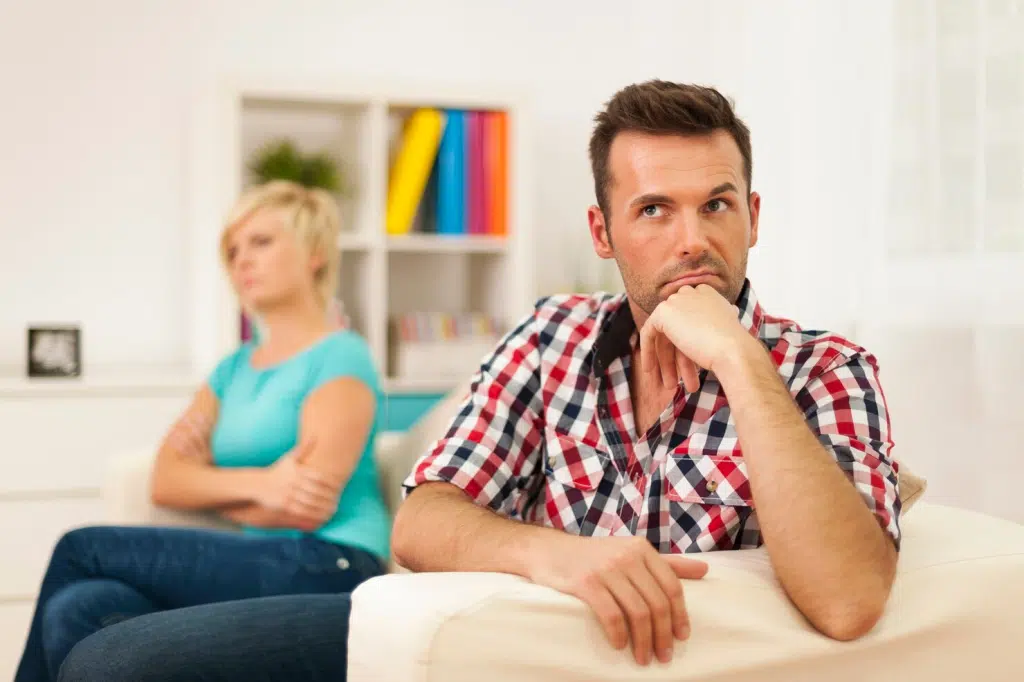 A man thinking while a woman behind him