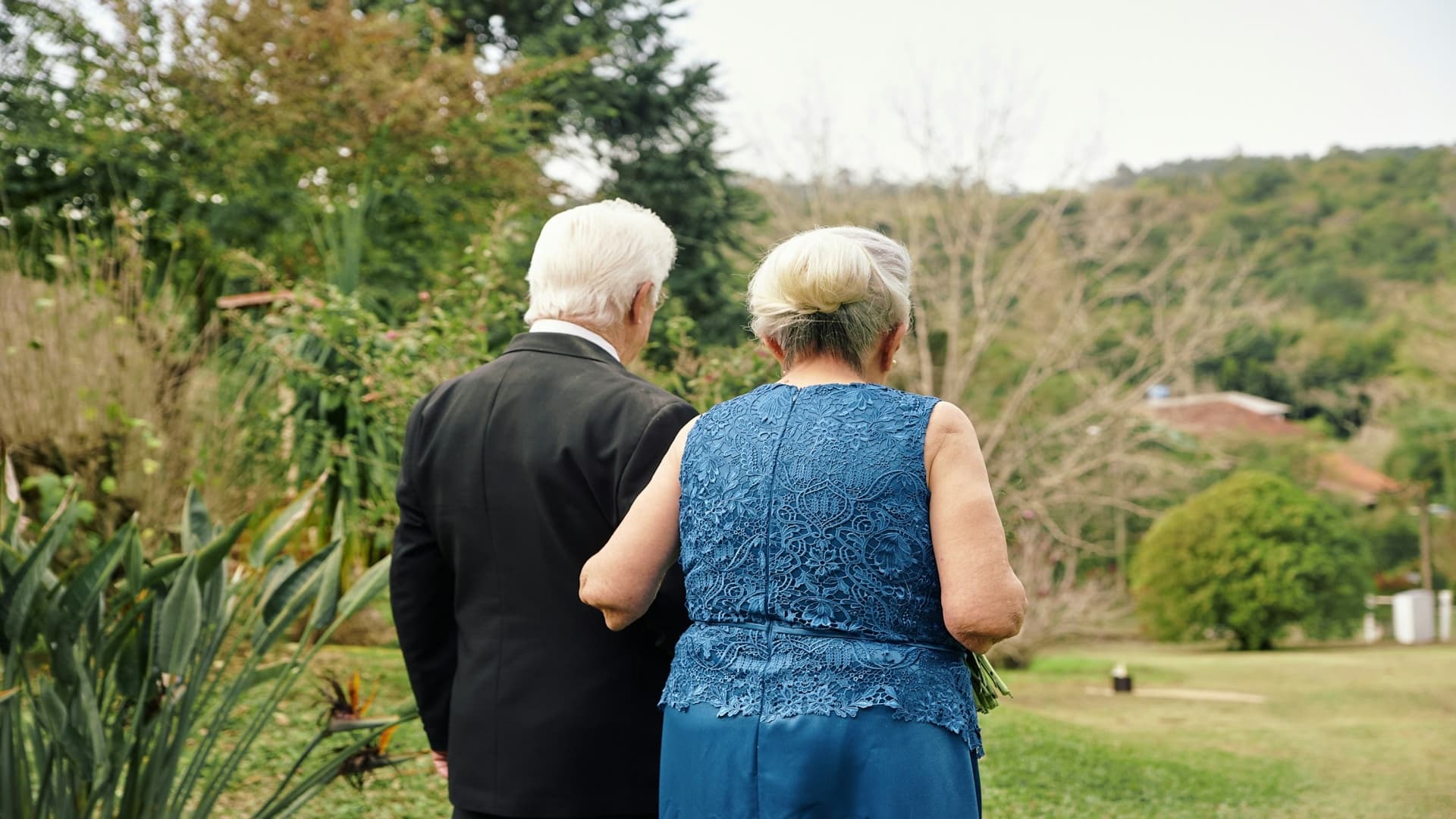 man standing supportively beside partner