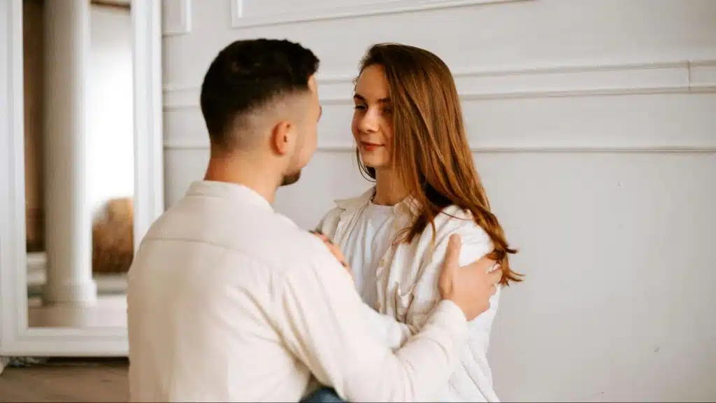 A man and woman facing each other 