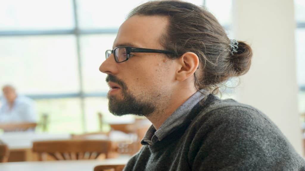 man listening attentively during conversation