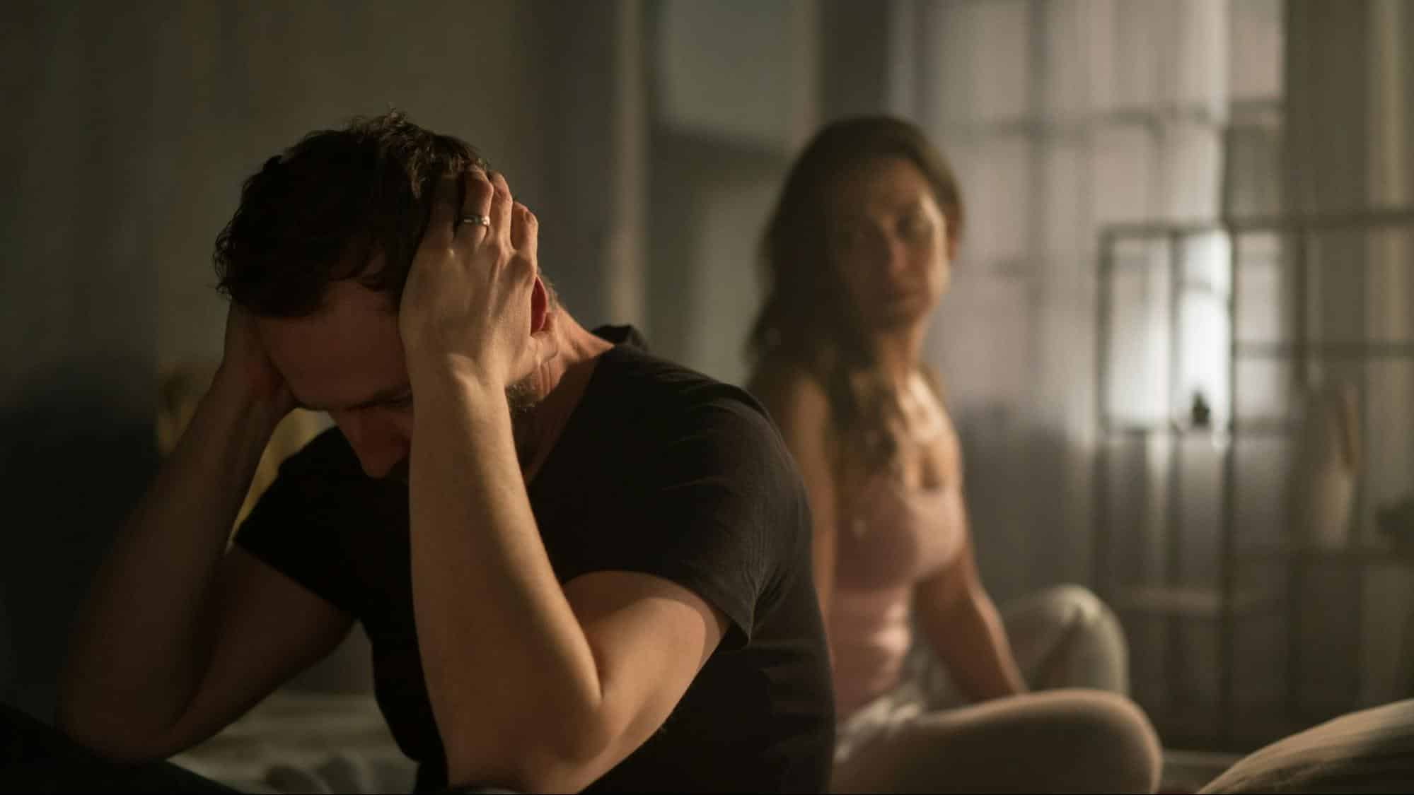 A man covering his ears from a woman