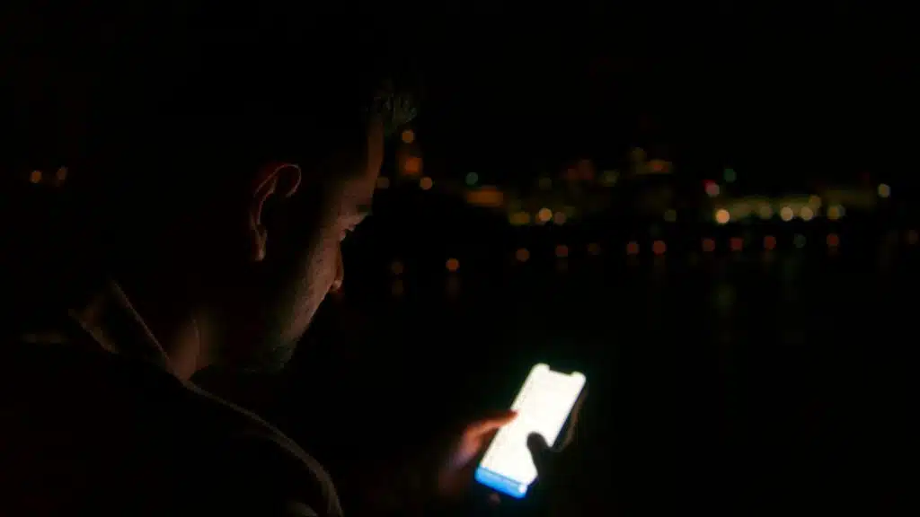 A man texting at night