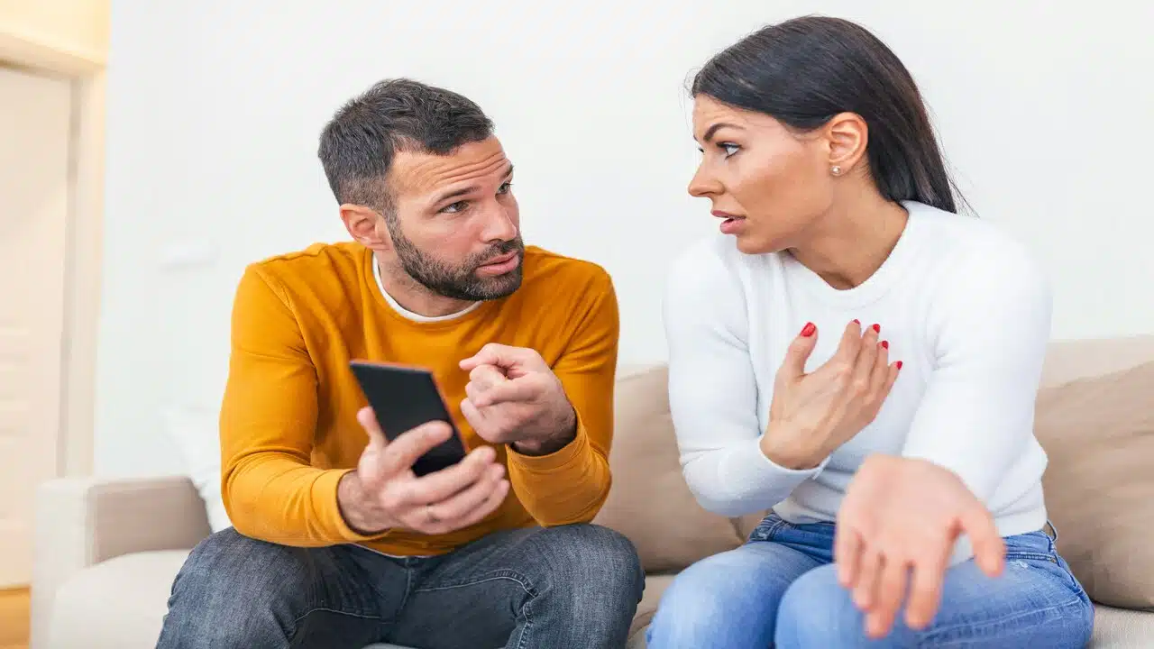 A couple arguing on the couch