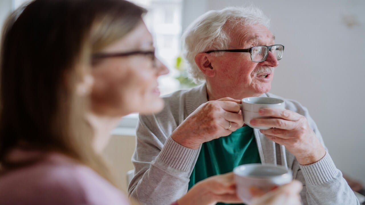 Elderly parents having coffee together