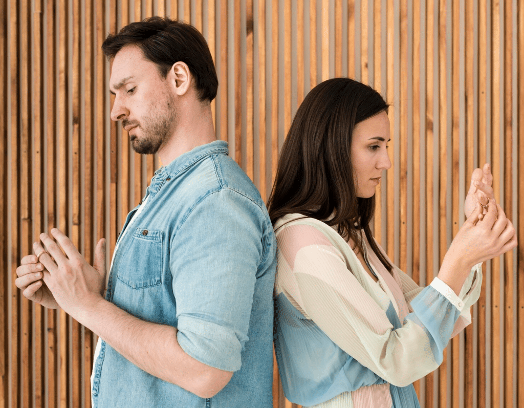 A man and woman removing their ring