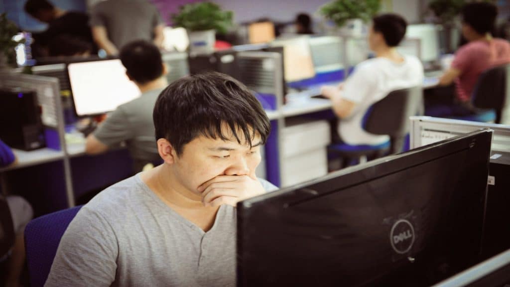 person looking stressed at desk