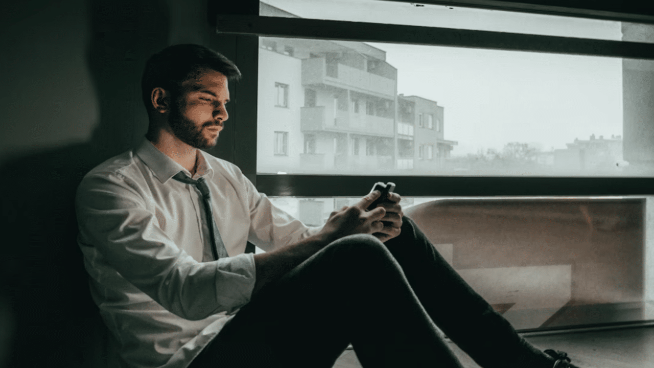 A man looking sad while texting