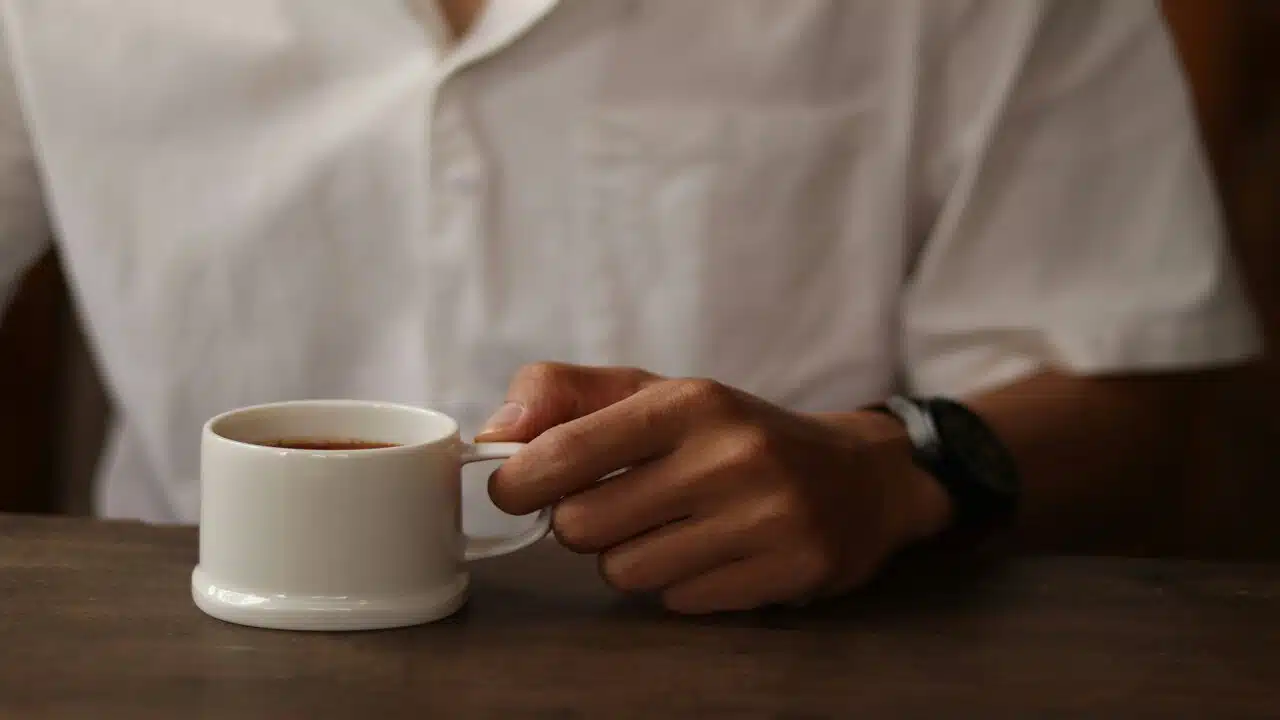 A man holding a cup of coffee