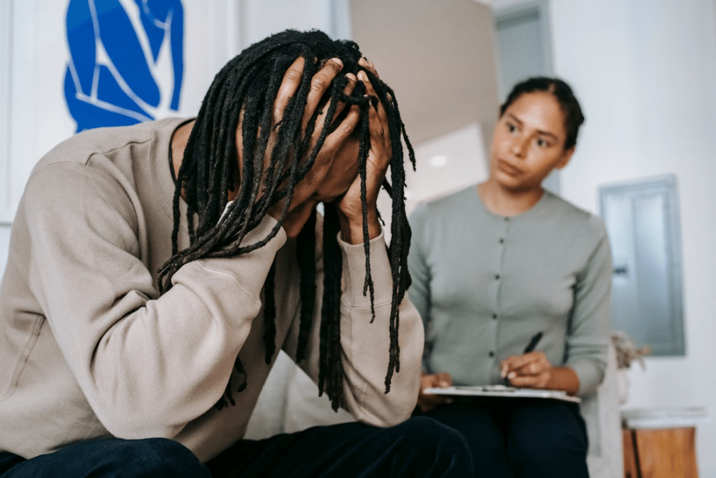 Upset man being criticized by woman