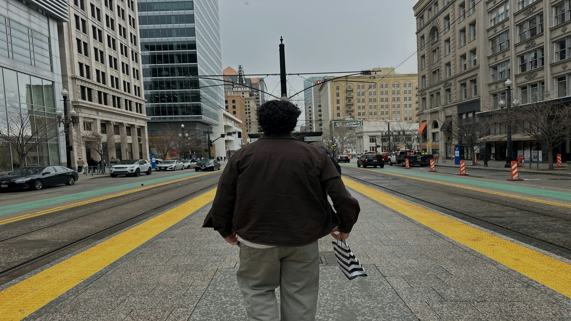 man standing confidently in city