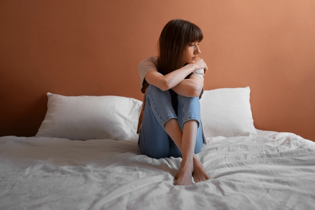 Unhappy and insecure woman in bed