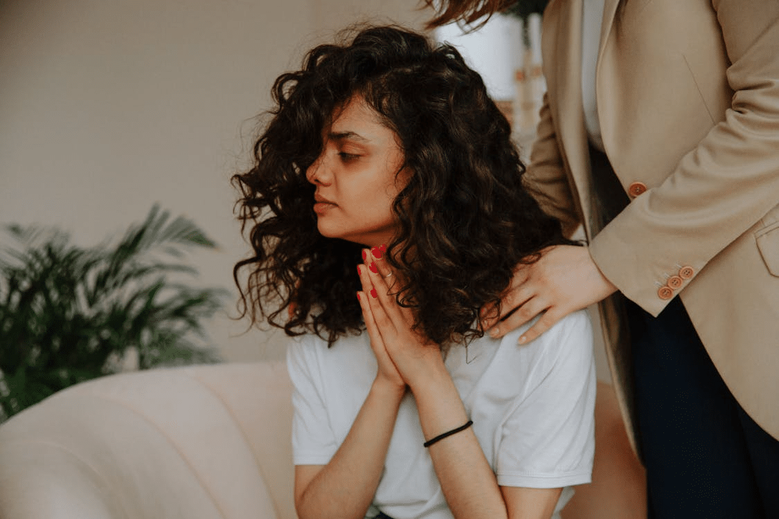 Sorrowful woman being comforted