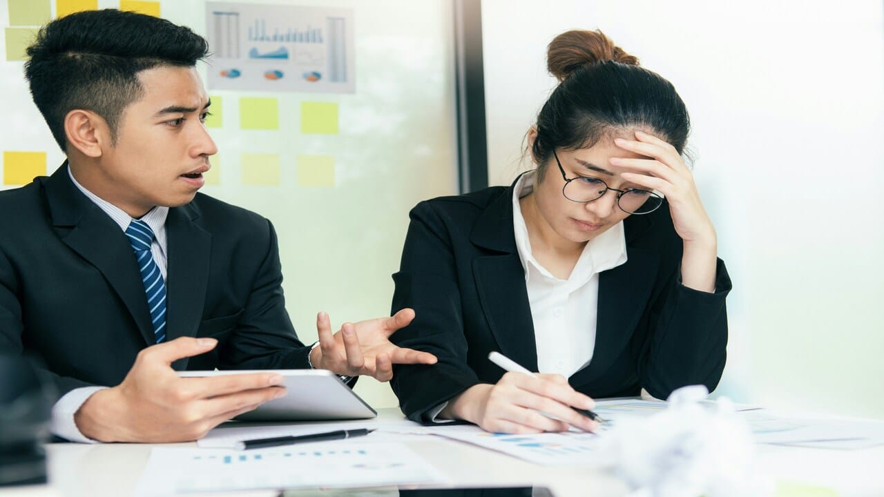 A man blaming a woman at work