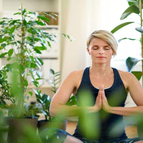 A woman doing yoga at home