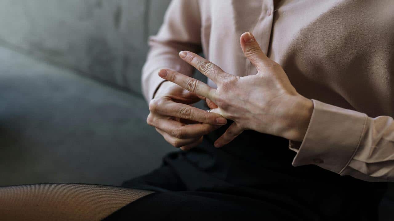 A woman taking off her ring