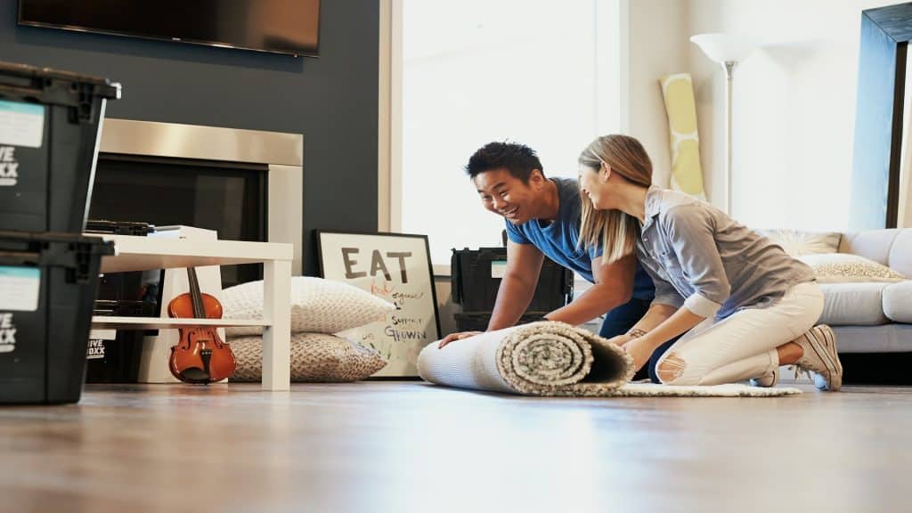 couple arranging furniture together