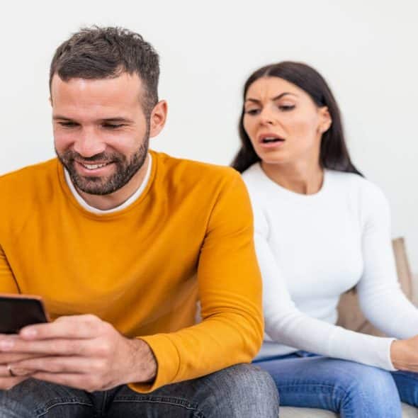 A woman suspicious at who her man is texting