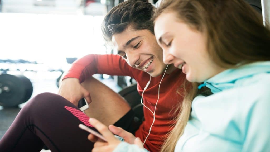 couple texting and smiling