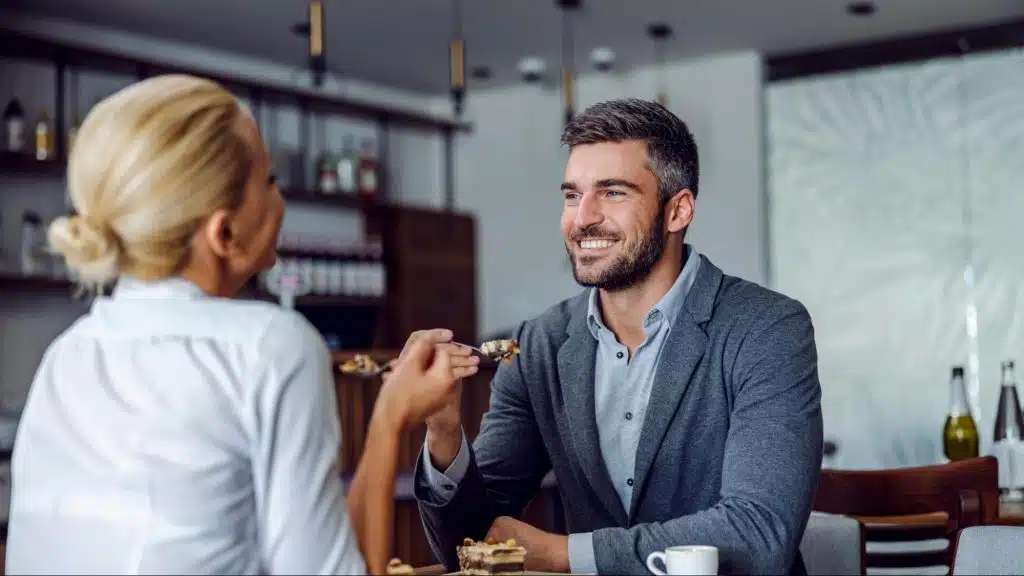 A man smiling to woman