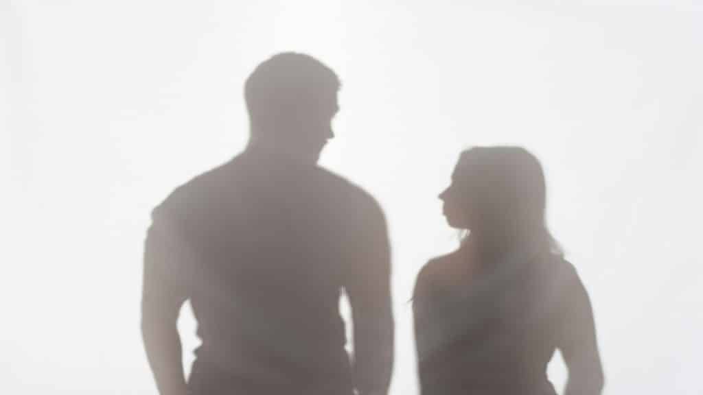 man standing beside partner confidently