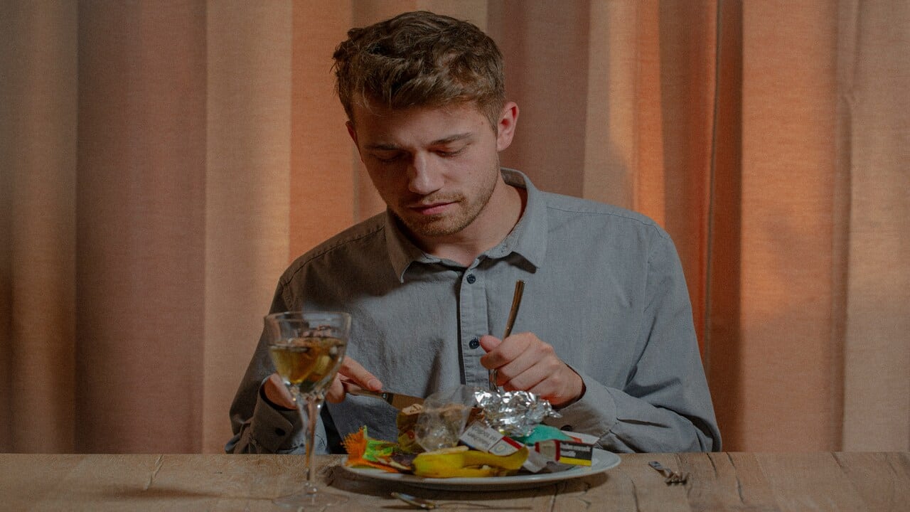 A man looking disappointed at his food