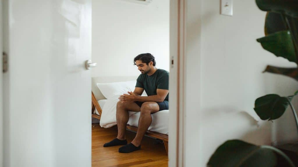 man sitting thoughtfully indoors