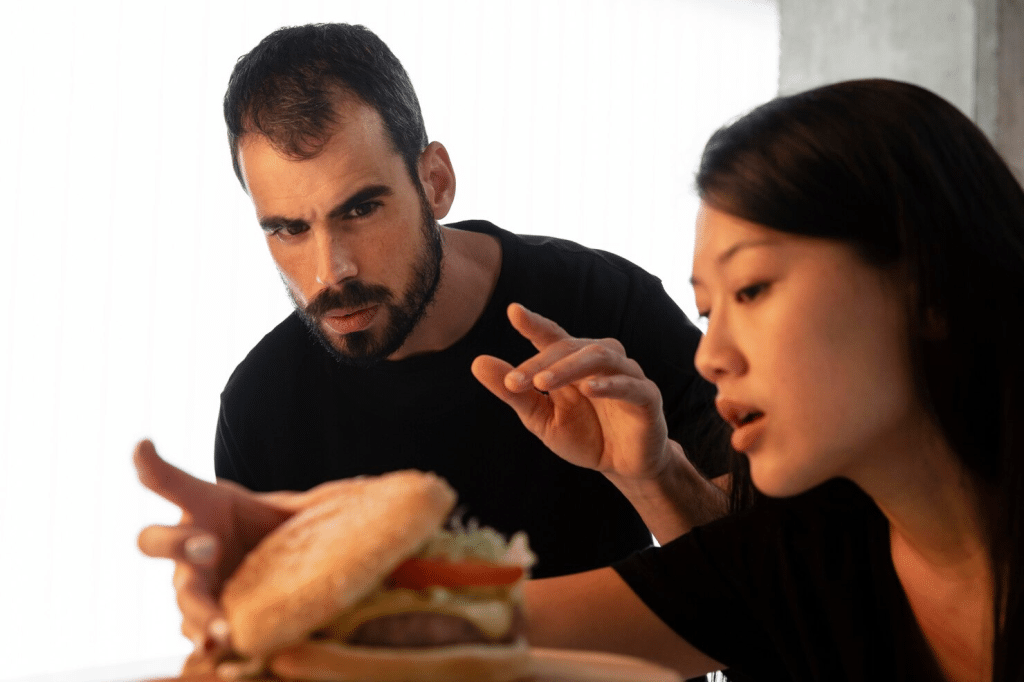A man talking to much and a woman trying to divert her attention
