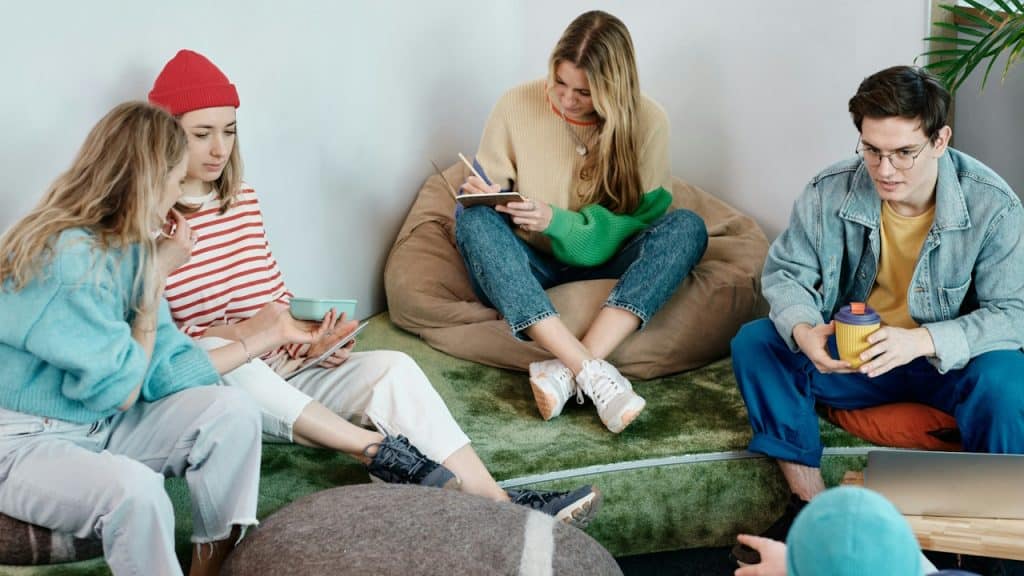 A group of people sitting and working together indoors.