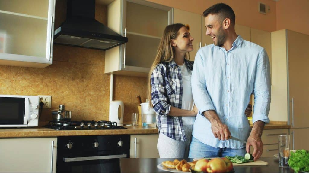 A man and woman at the kitchen