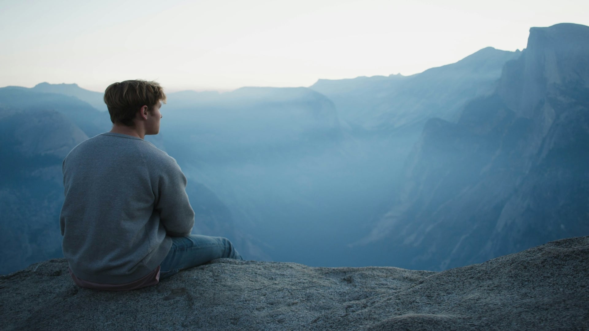 man sitting calmly outdoors