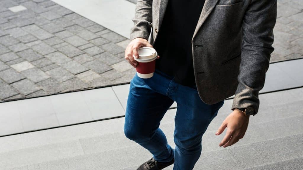man bringing coffee to partner
