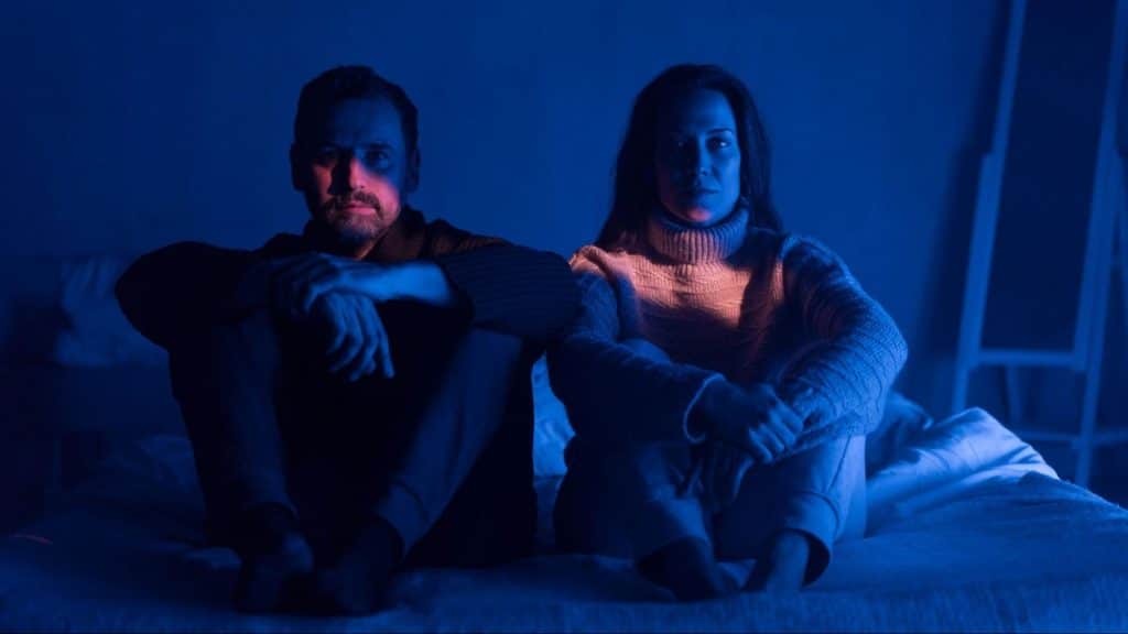 A man and woman sitting beside each other 