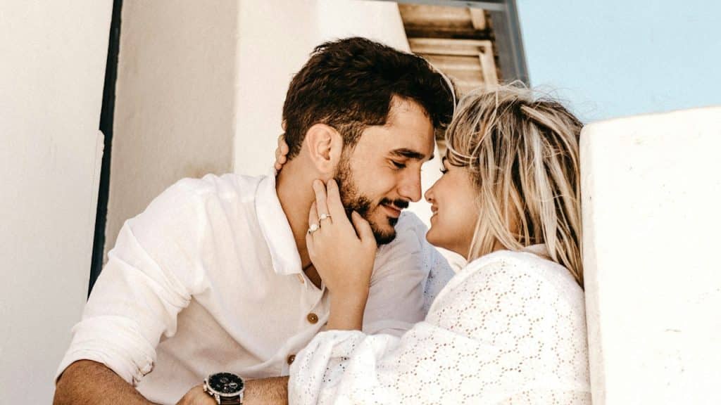 Smiling man and woman about to kiss each other.
