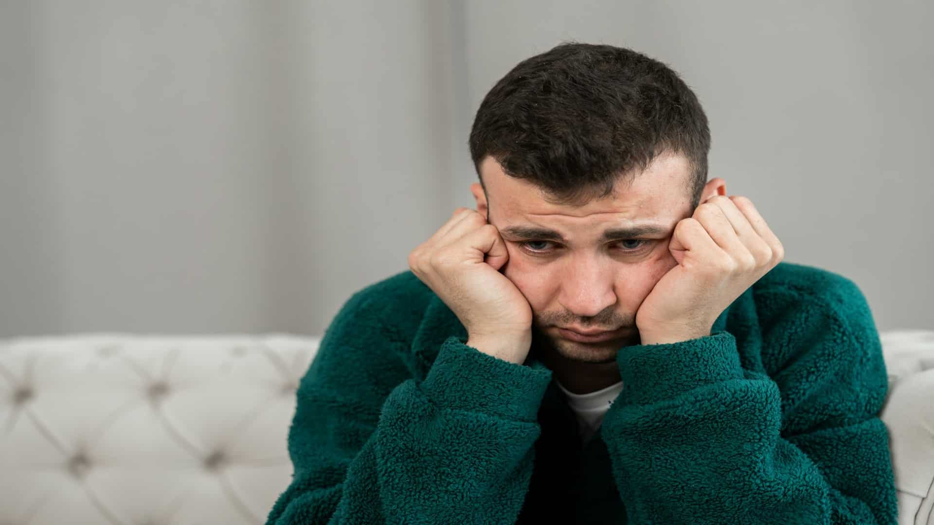 man sitting alone on couch