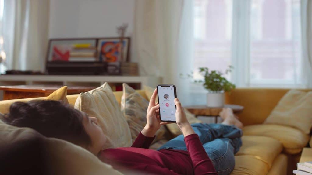 A woman swiping through a dating app