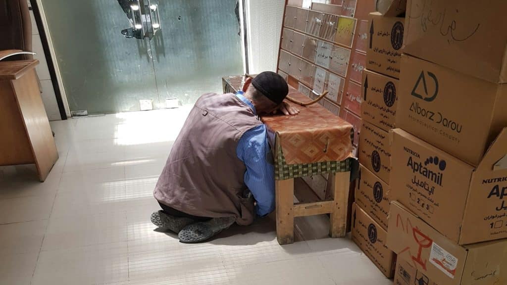 man resting head while working