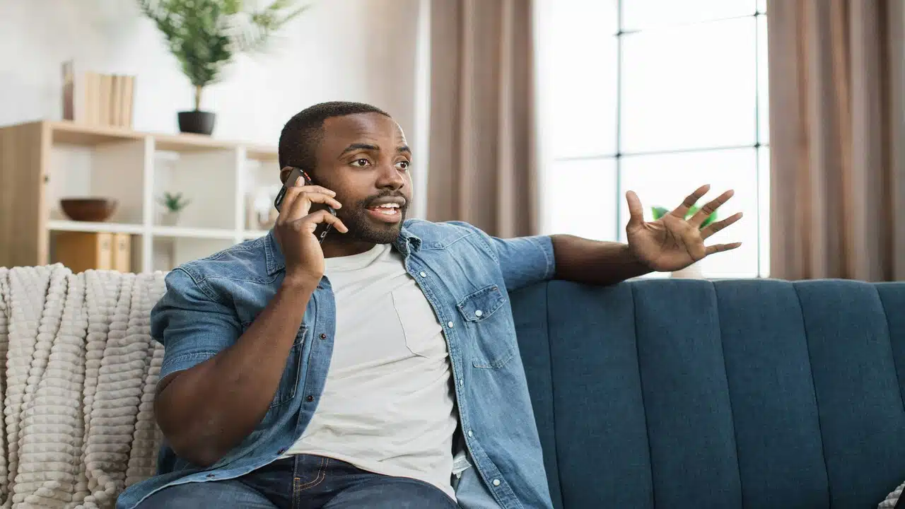 A man talking animatedly on the phone