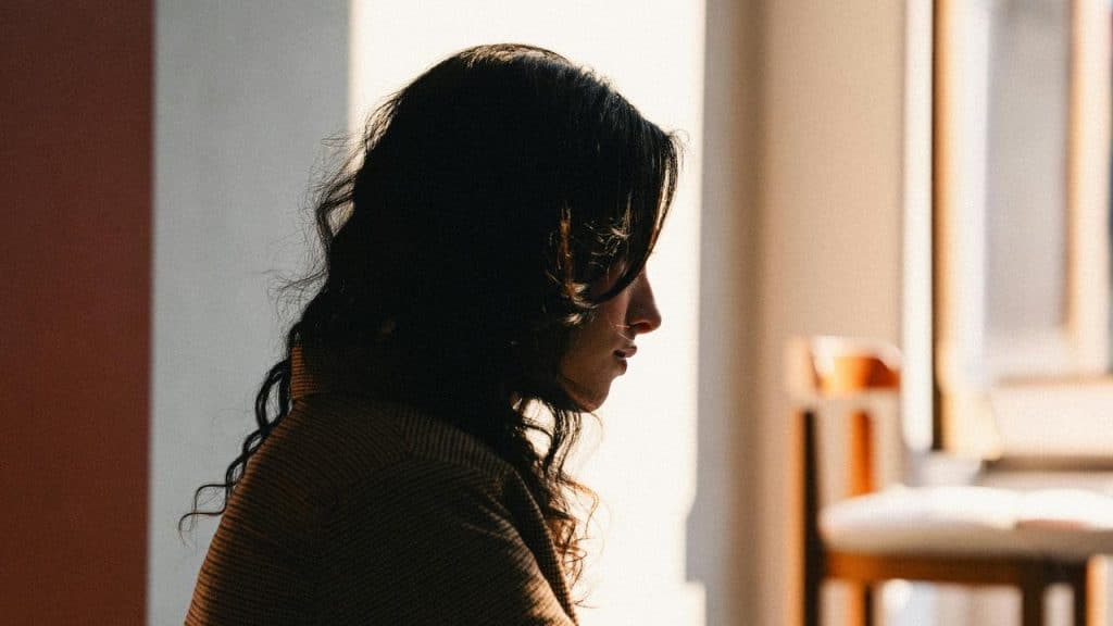 A woman sitting by a window