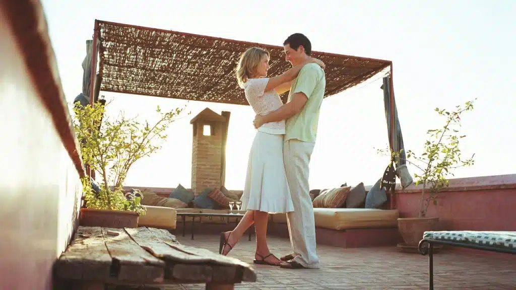A couple embraces on a sunny rooftop