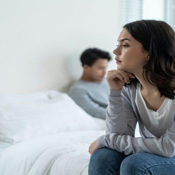 A couple ignoring each other in the bedroom