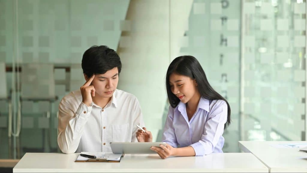 A man stressed while woman talks to him