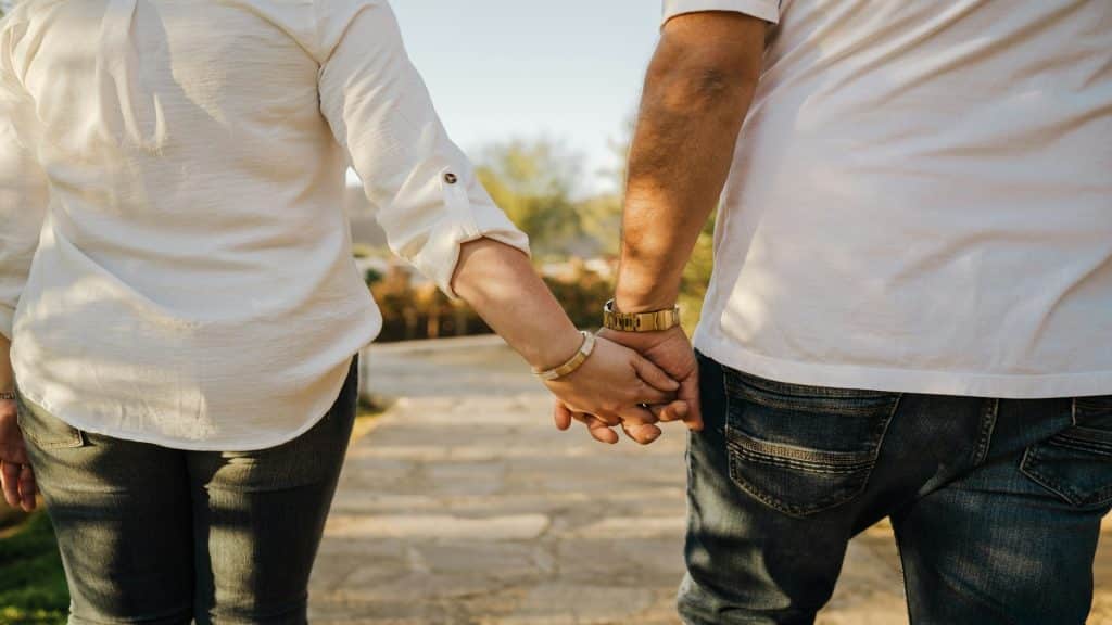 couple holding hands during walk