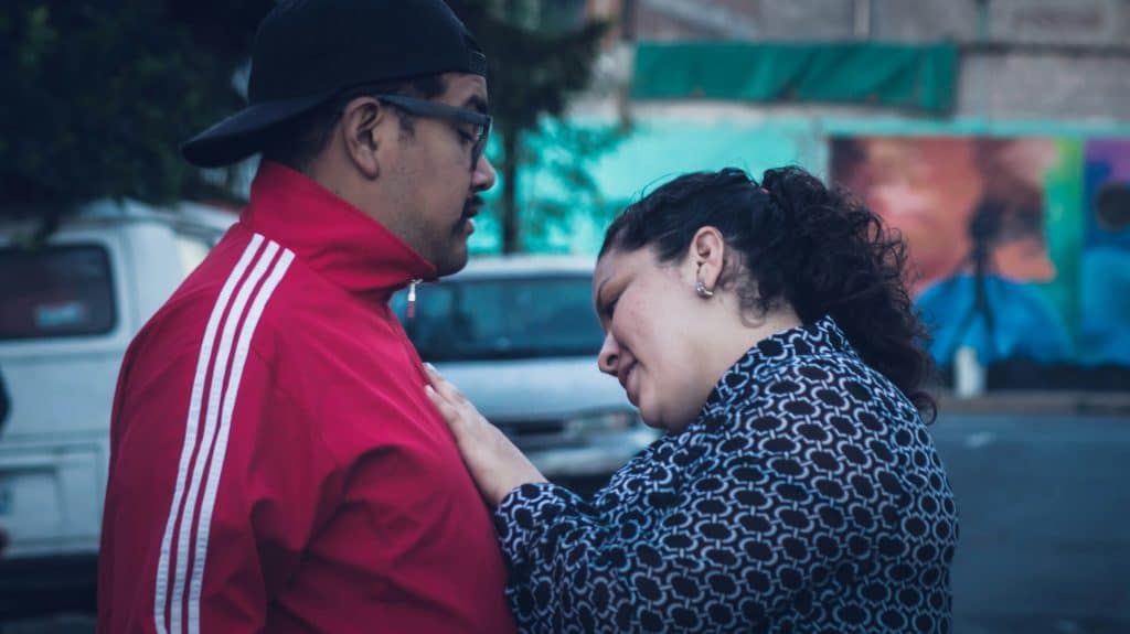 woman comforting man during a moment