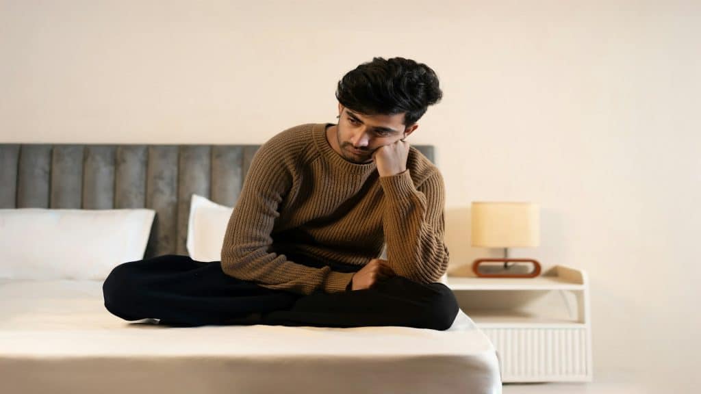man sitting alone looking thoughtful