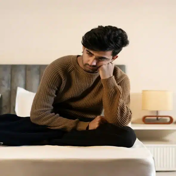 man sitting alone looking thoughtful