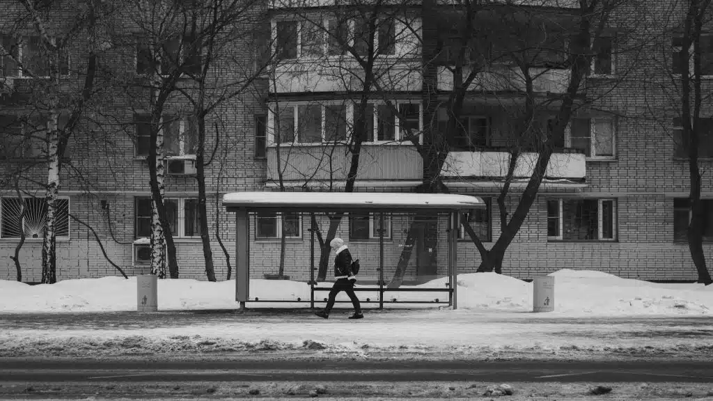 man walking alone outside apartment